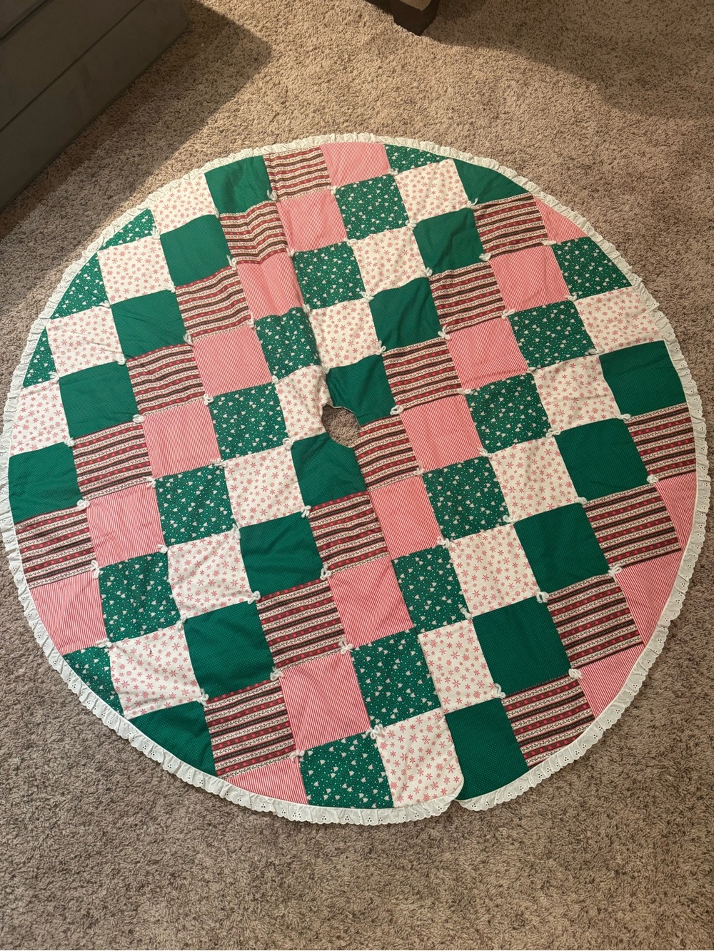 Handmade quilted patchwork Christmas tree skirt with red-and-green fabrics